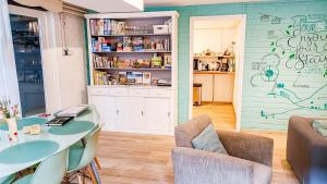 a room with a table and chairs and a kitchen at Vakantiewoning Valkenburg in Valkenburg +41 photos