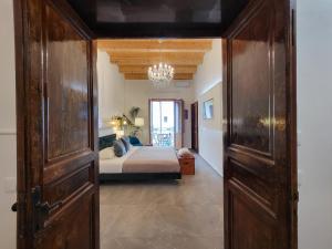 カステッランマーレ・デル・ゴルフォにあるAtriumのベッドルーム1室(ベッド1台付)、大きな木製ドアが備わります。