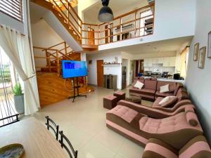 a large living room with a couch and a television at Luhana Chincha® Hermosa Casa de Playa in Casa Blanca