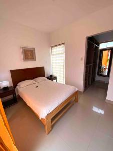 a bedroom with a large bed in a room at Luhana Chincha® Hermosa Casa de Playa in Casa Blanca