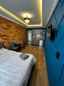 a bedroom with a bed and a blue door at Байтеке in Bishkek