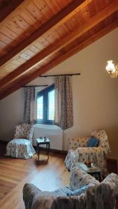 a living room with a couch and two chairs at Agnes Cottage House in Konitsa