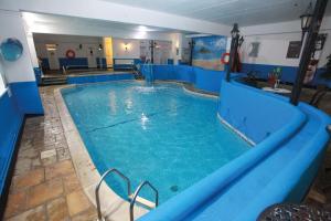 a large blue swimming pool in a hotel at Bell Cottage in Penzance