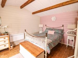 a bedroom with a bed and a wooden floor at Westfield Lodge in York
