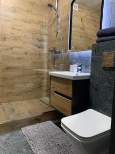 a bathroom with a toilet and a sink and a shower at Дизайнерські апартаменти в ЖК DreamTown 10а in Lutsk