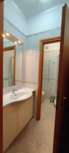 a bathroom with a sink and a mirror and a tub at Blu Trieste in Trieste +13 photos
