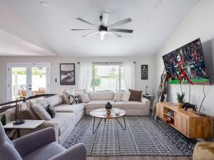 a living room with a couch and a ceiling fan at Scottsdale - 6839 E Kelton Lane in Scottsdale