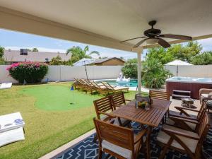 a patio with a table and chairs and a putting green at Scottsdale - 6839 E Kelton Lane in Scottsdale