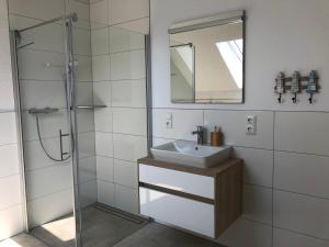 a bathroom with a sink and a shower at Auszeit im Grünen 