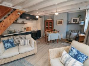 a living room with two couches and a table at Rose Lea in Saltburn-by-the-Sea