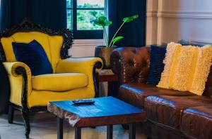 a living room with two chairs and a couch at Cozy and quirky Wolf Apartment in Paramaribo