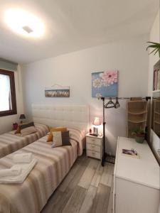 מיטה או מיטות בחדר ב-Appartamento Le Ginestre