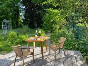 a wooden table and two chairs on a patio at Bed & Breakfast am Rheinsteig Bad Honnef in Bad Honnef am Rhein