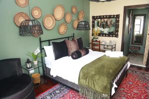 a bedroom with a bed with pillows and a mirror at Villa Grande Luxury accommodation in Welkom +158 photos