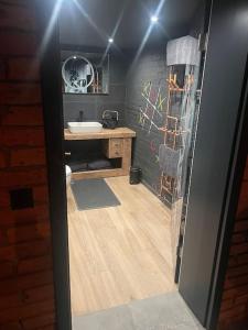 a bathroom with a sink and a mirror at Ferienwohnung Loft Schwielowsee mit Sauna in Schwielowsee