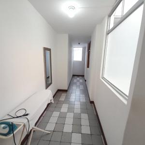 a corridor of a hospital with a bed and a window at Hepico Departamentos Piura in Piura