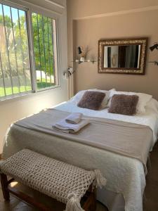 a large bed in a room with a window at Chacras de Coria Relax in Ciudad Lujan de Cuyo