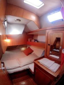 a small room with a bed in the back of a boat at XSail mediterraneo sport experience in Piombino