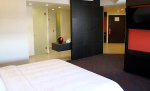 a bedroom with a white bed and a black wall at Holiday Inn Mexico Dali Airport, an IHG Hotel in Mexico City
