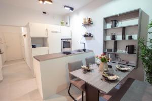 a kitchen and dining room with a table and chairs at TANIC Deluxe Apartment Garden Central Industrial Fair in Düsseldorf