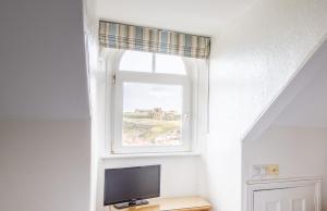 a window in a room with a television on a table at Number 7 Guest House in Whitby