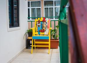 a colorful chair sitting on a balcony at Cozy and quirky Wolf Apartment in Paramaribo