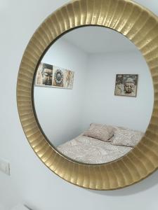 a mirror with a bed in a room at Apartamento Meraki in Santa Cruz de Tenerife