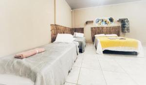 a room with two beds in a room at Loft Familiar BR-Aeroporto 1 in Uberlândia +3 photos