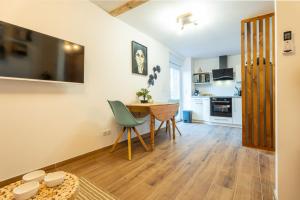 a kitchen and dining room with a table and chairs at LA P'TITE EVASION in Heimsbrunn