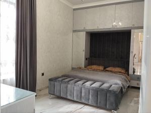 um quarto com uma cama grande e uma cabeceira preta em Apartaments Hayat em Guiumri