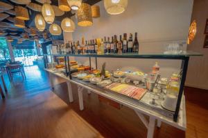 a buffet line with food and drinks in a restaurant at George V Alto De Pinheiros in Sao Paulo