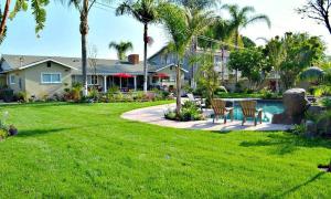 a house with a yard with a swimming pool at Destination #03 in Fullerton