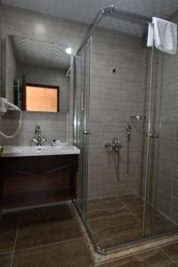 a bathroom with a shower and a sink at Burcu Kaya Hotel in Ortahisar