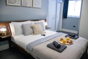 a bedroom with a bed with a tray of food on it at Flat in Nottingham City Centre in Nottingham
