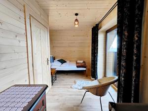 a small room with a bed in a wooden cabin at Osada pod Giewontem in Czerwienne