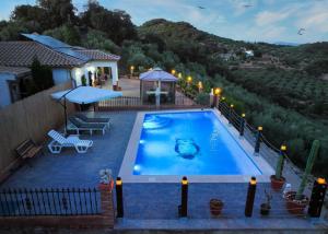 a swimming pool with a view of a house at Cortijo La Solana Montefrío in Montefrío