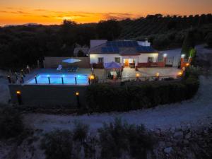a house with solar panels on it at sunset at Cortijo La Solana Montefrío in Montefrío