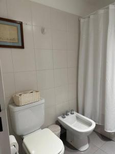 a white bathroom with a toilet and a shower curtain at Excellent apartment brand new in San Isidro