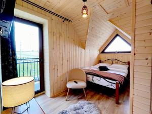 a bedroom with a bed in a room with a window at Osada pod Giewontem in Czerwienne