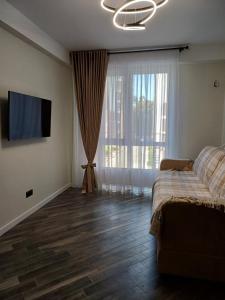 a bedroom with a bed and a flat screen tv at Airport Chisinău 24/24!!! Parking, taxi. in Chişinău