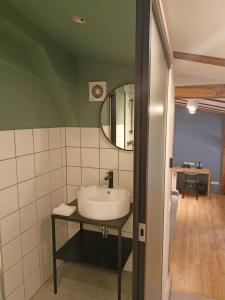 a bathroom with a sink and a mirror at So in Sopot Station in Sopot