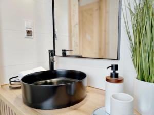a bathroom with a black sink and a mirror at Osada pod Giewontem in Czerwienne