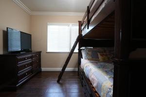 a bedroom with a bunk bed and a television at Destination #19 in Anaheim