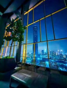 a room with a view of a city from a building at Grand Residence Suite At Opus Kuala Lumpur in Kuala Lumpur