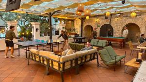 a group of people playing ping pong in a patio with a pool table at Viajero Quito Hostel in Quito