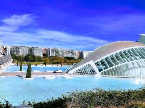 a large swimming pool with a building in the background at Apartament in Monte Pedreguer in Pedreguer