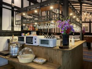 a counter with two microwaves and flowers on it at Hakuba Sun Valley Hotel Annex - Vacation STAY 40560v in Hakuba