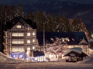 a building with lights on in the snow at night at Hakuba Sun Valley Hotel Annex - Vacation STAY 40560v in Hakuba