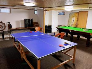 a ping pong table in a room with a pool table at Hakuba Sun Valley Hotel Annex - Vacation STAY 40560v in Hakuba