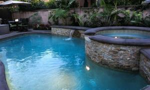 a pool with a water feature in a yard at Destination #28 in Anaheim